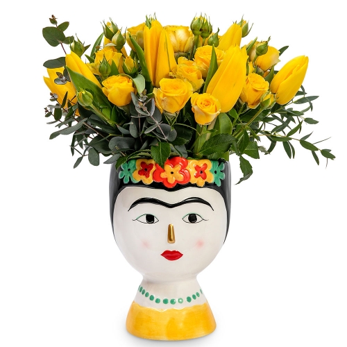 Yellow flowers in a Frida Kahlo vase